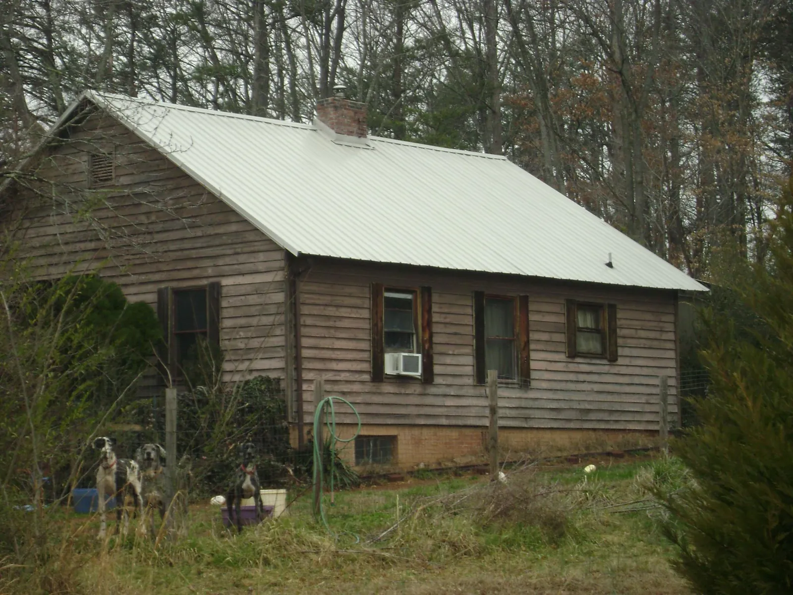 White metal roof on an old wood sided farmhouse, from a Metal Roof Installation job in Roma