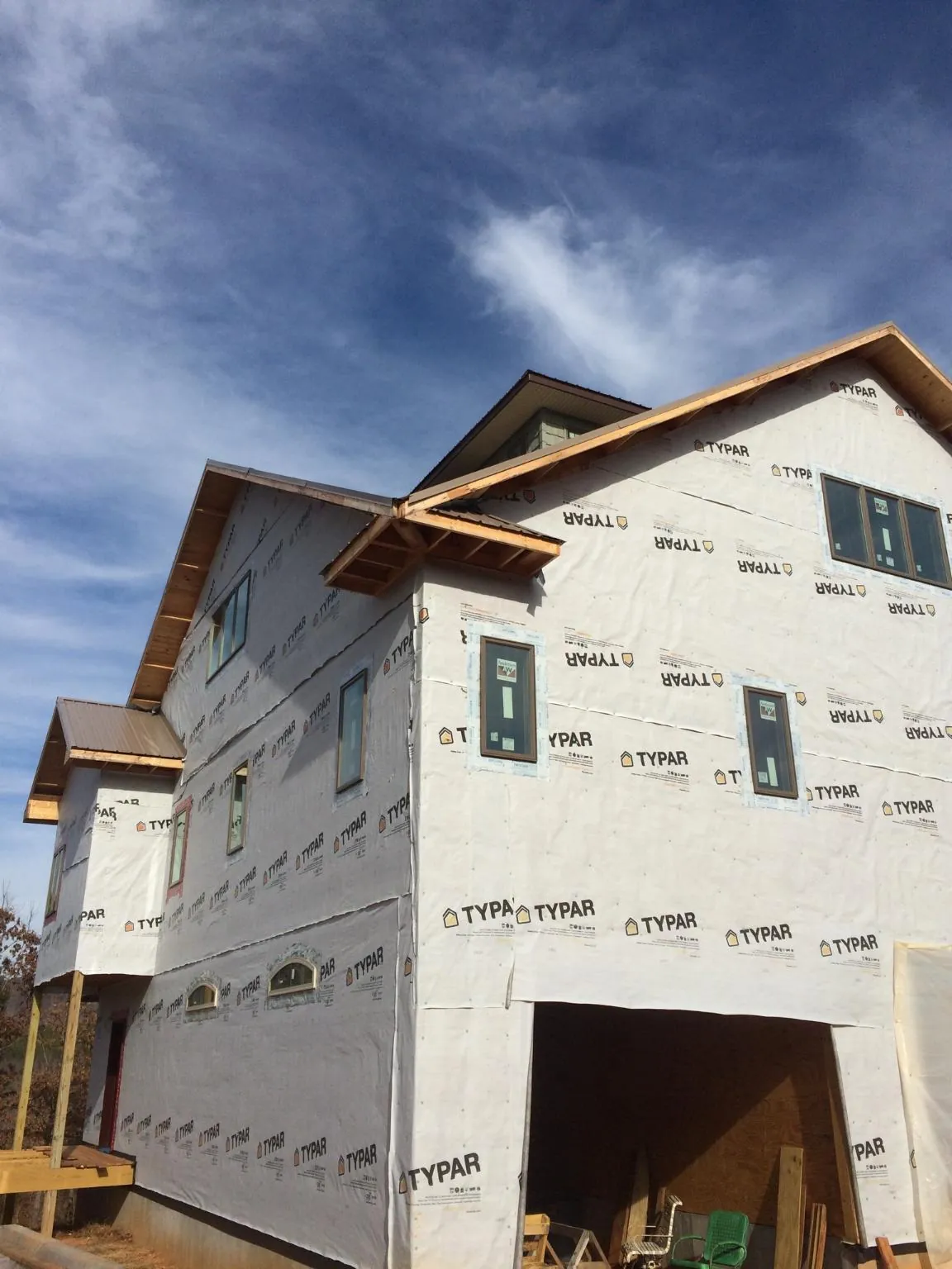 Stick built house wrapped in Typar with new roof framing and dormers in Roma